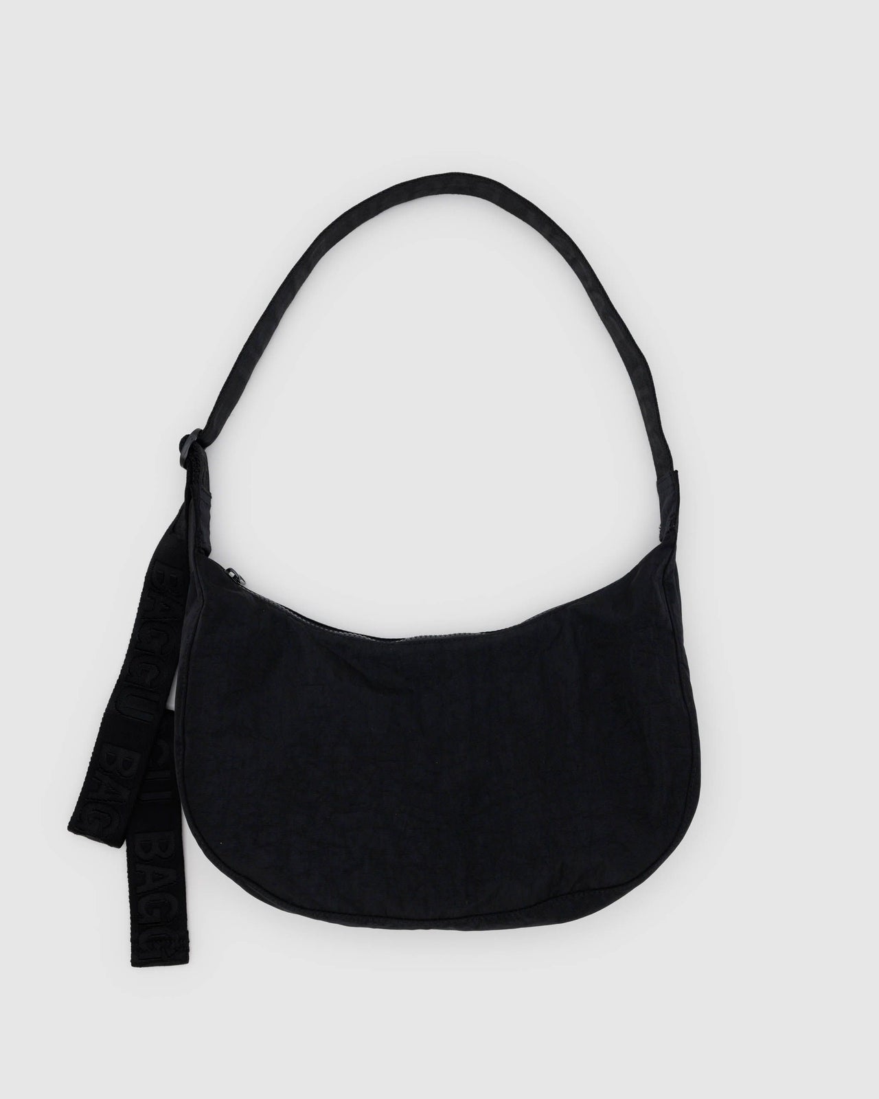 A black nylon crescent-shaped handbag with an adjustable strap and a small logo on the exterior.
